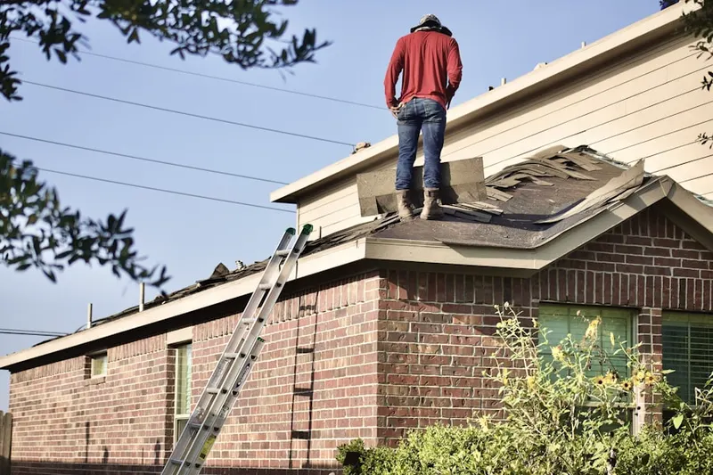 Professional roofer working on a residential roof in Rowley